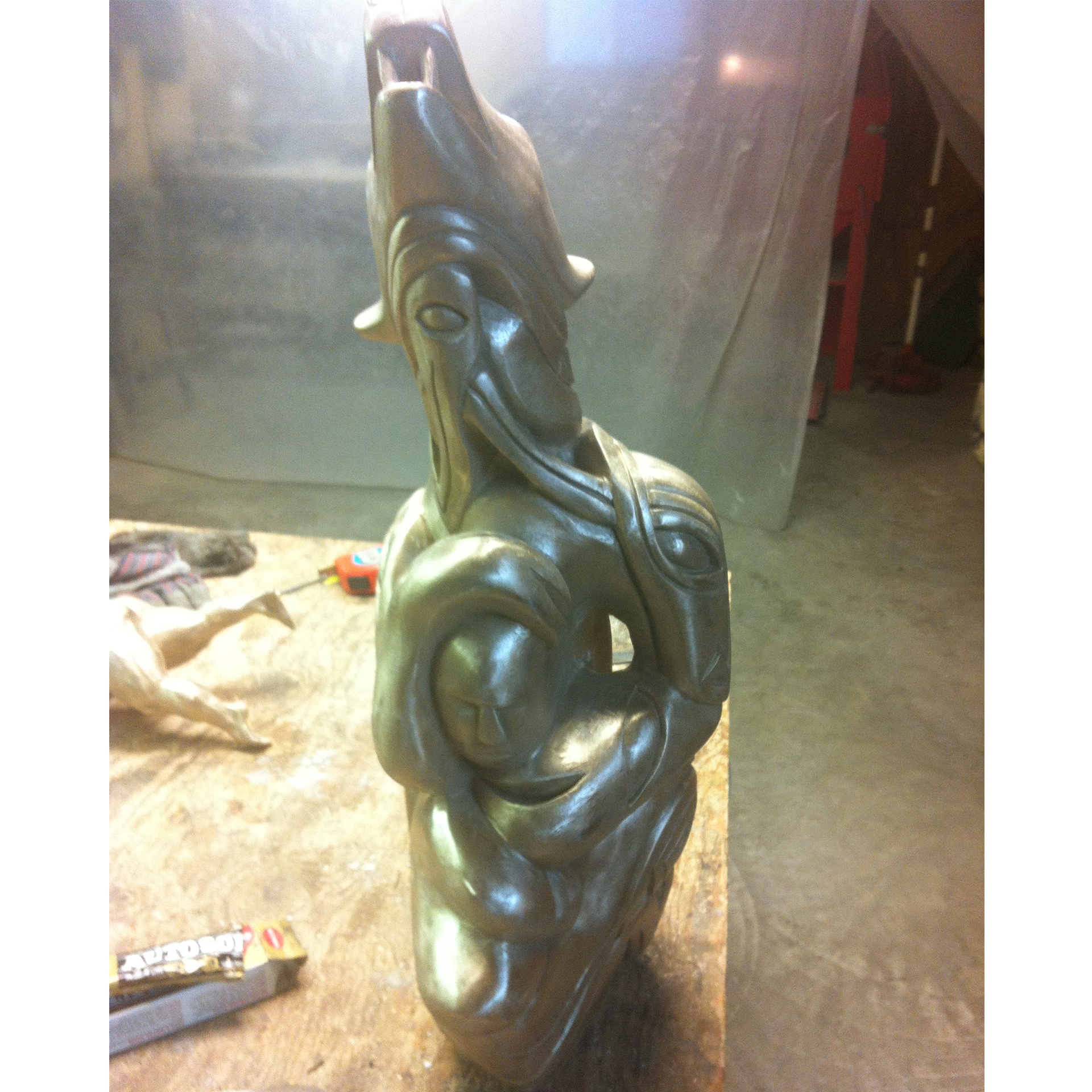 Bronze sculpture recreation of a bear in a workshop setting