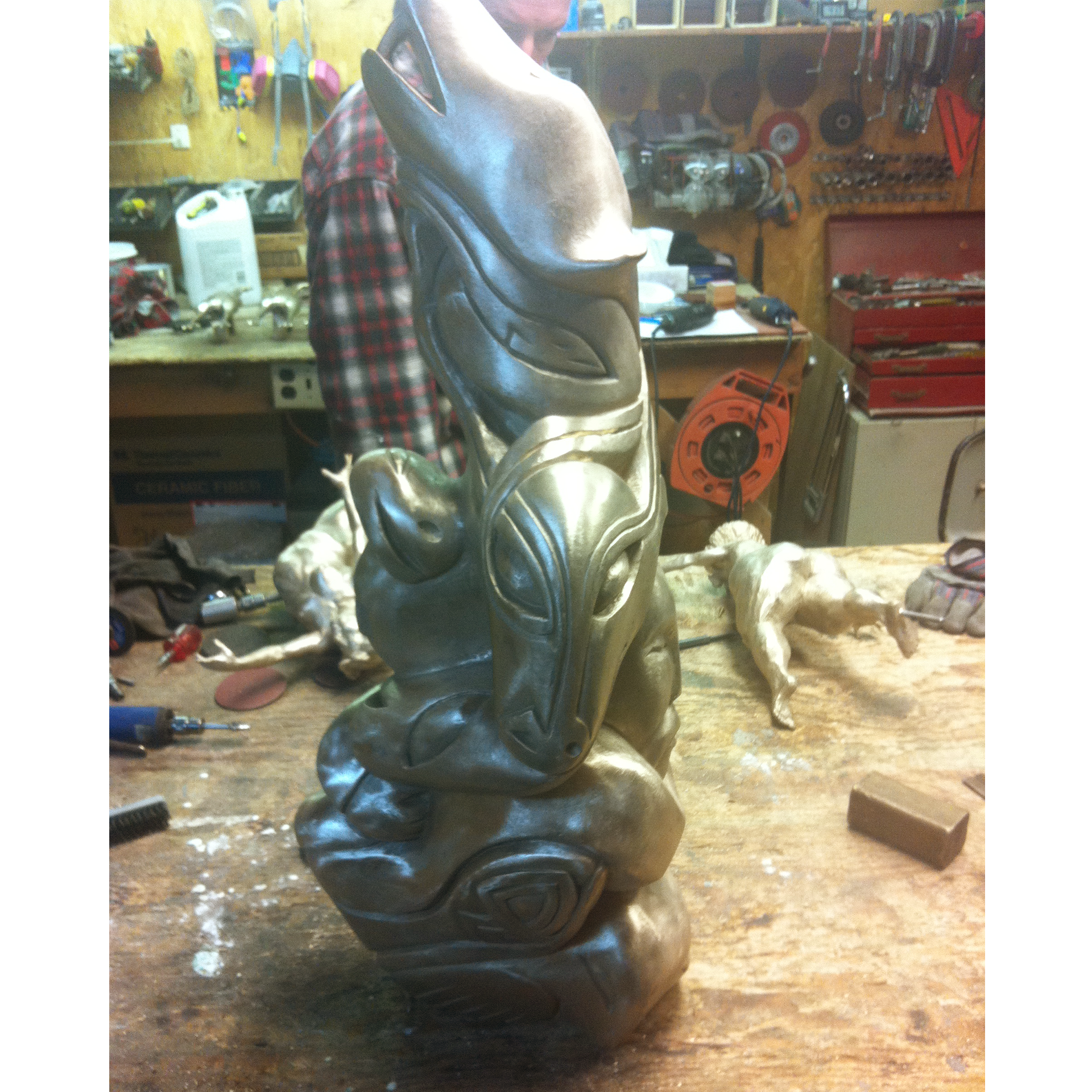 Bronze sculpture recreation of a bear in a workshop setting