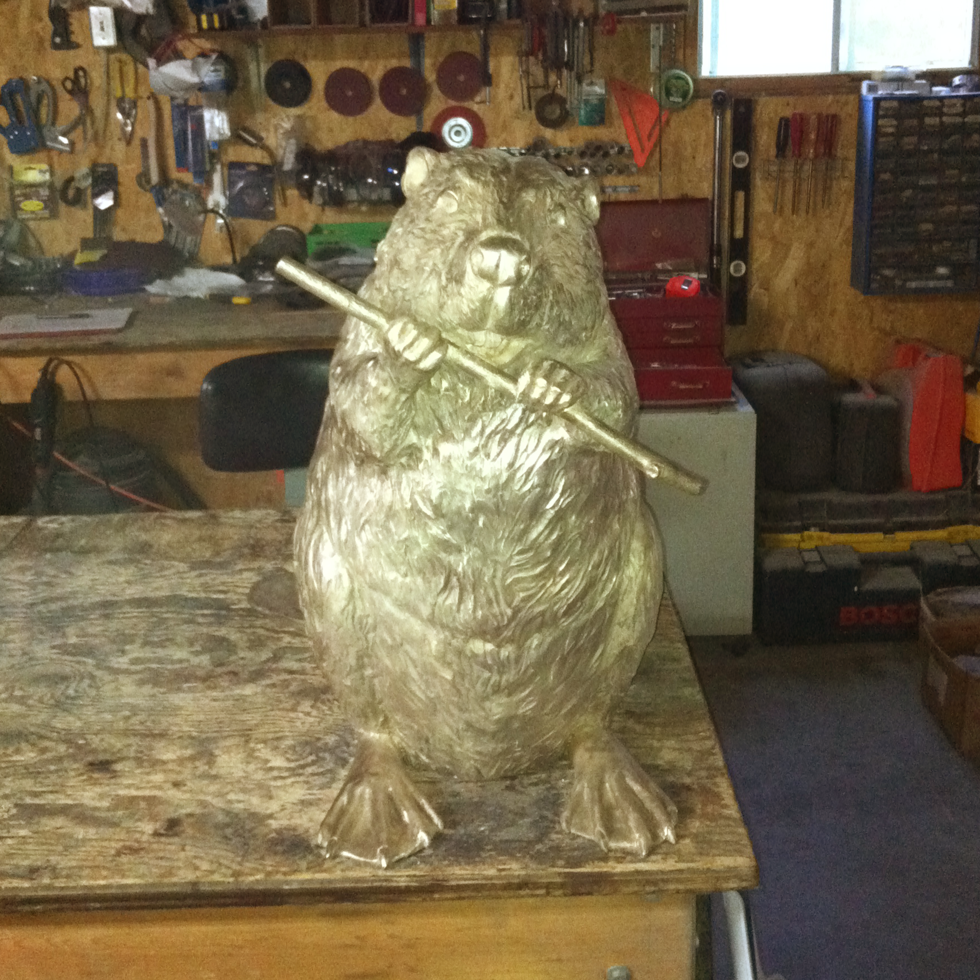 Bronze sculpture recreation of a beaver in a workshop setting
