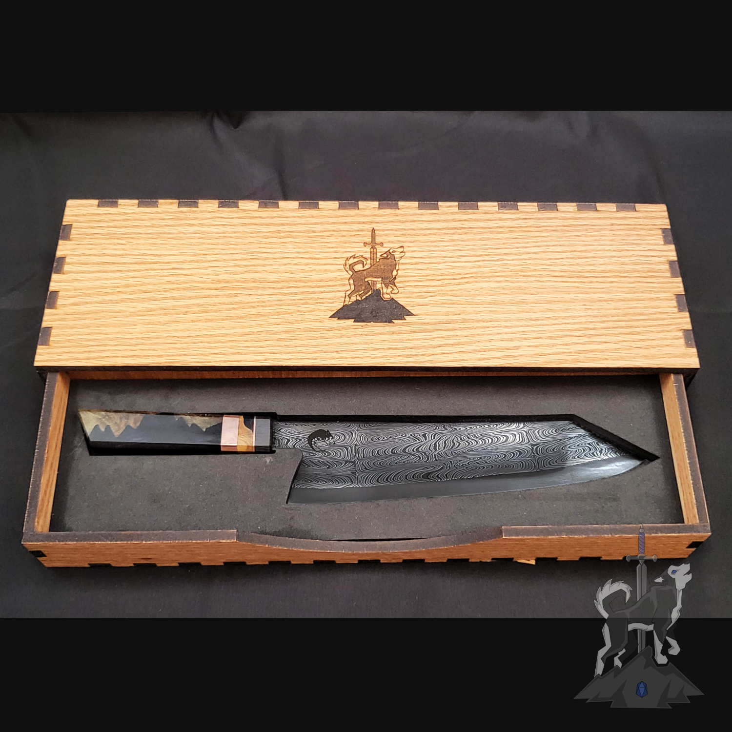 Damascus chef's knife in a wooden box with engraved design on a dark background