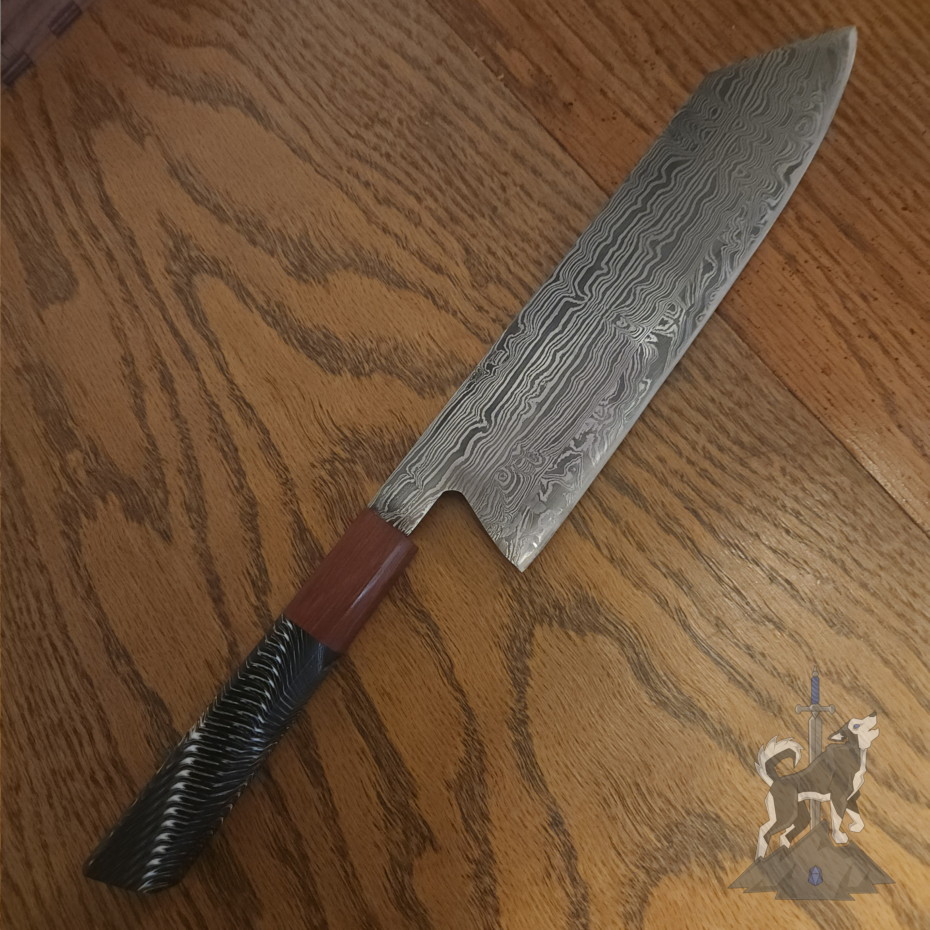 Chef knife with Damascus pattern on a dark wooden surface.
