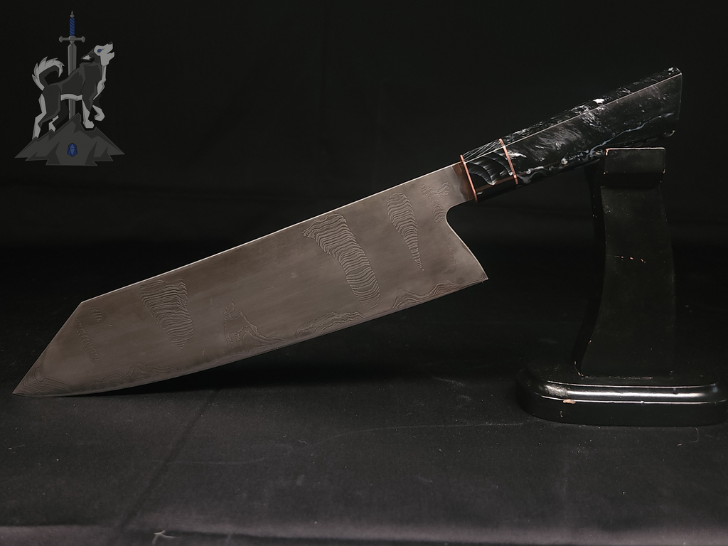 Chef knife with Damascus pattern on a stand with a dark background.