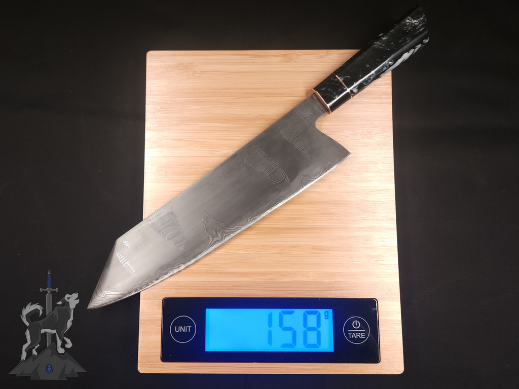 Chef's knife with a Damascus pattern on a digital kitchen scale displaying weight.
