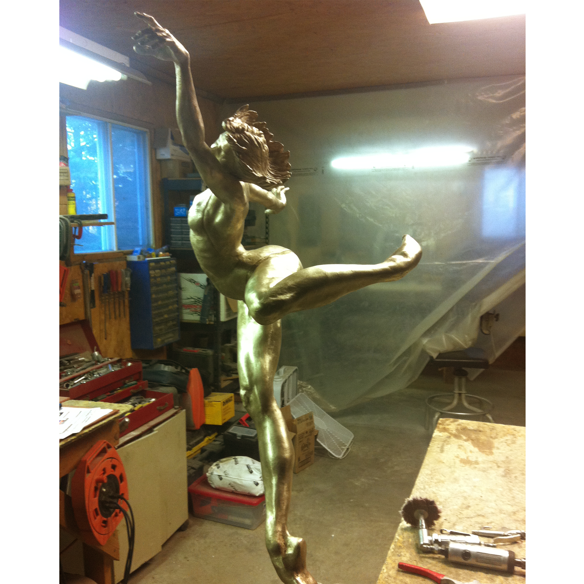 Bronze sculpture recreation of dancers in a workshop setting
