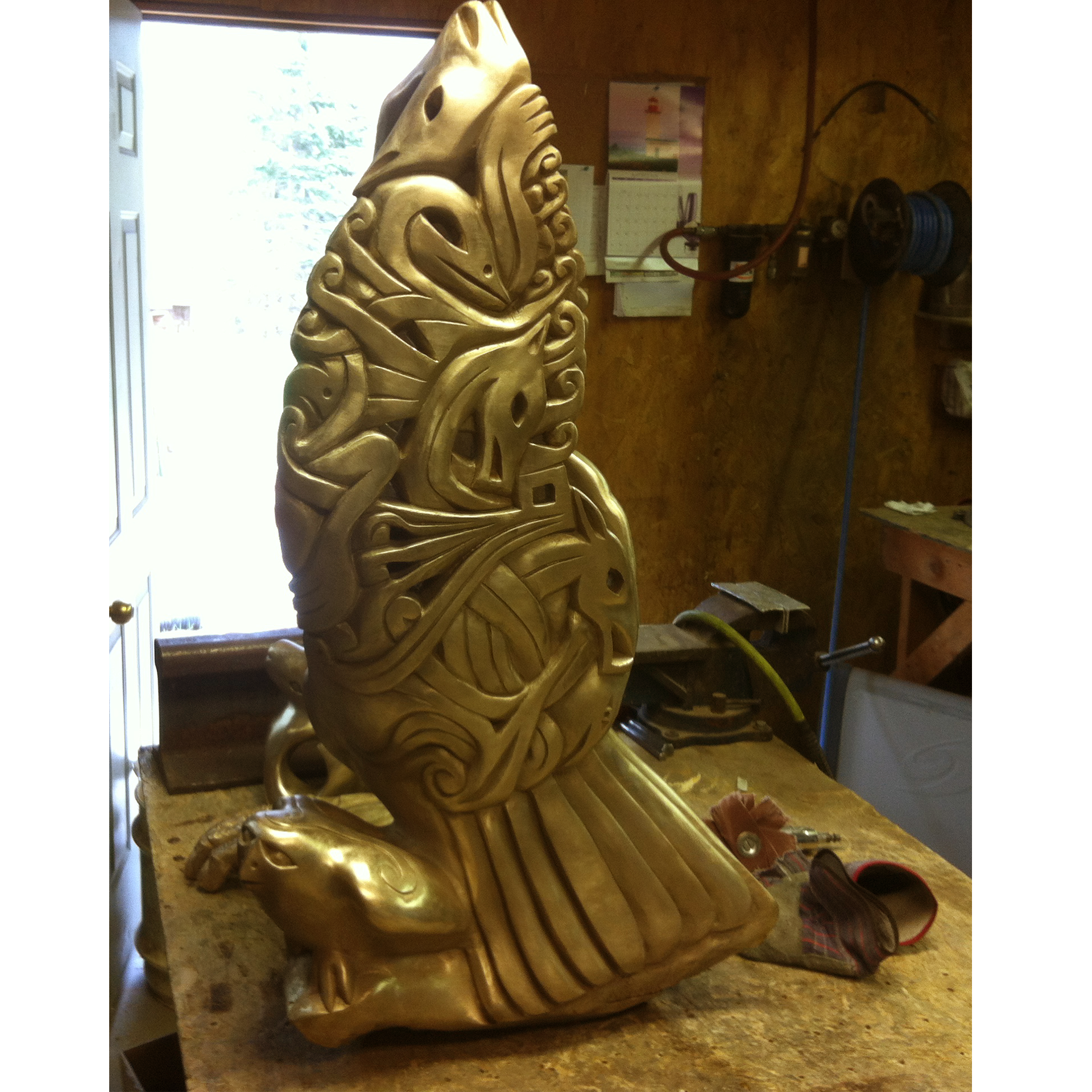 Bronze sculpture recreation of an eagle in a workshop setting
