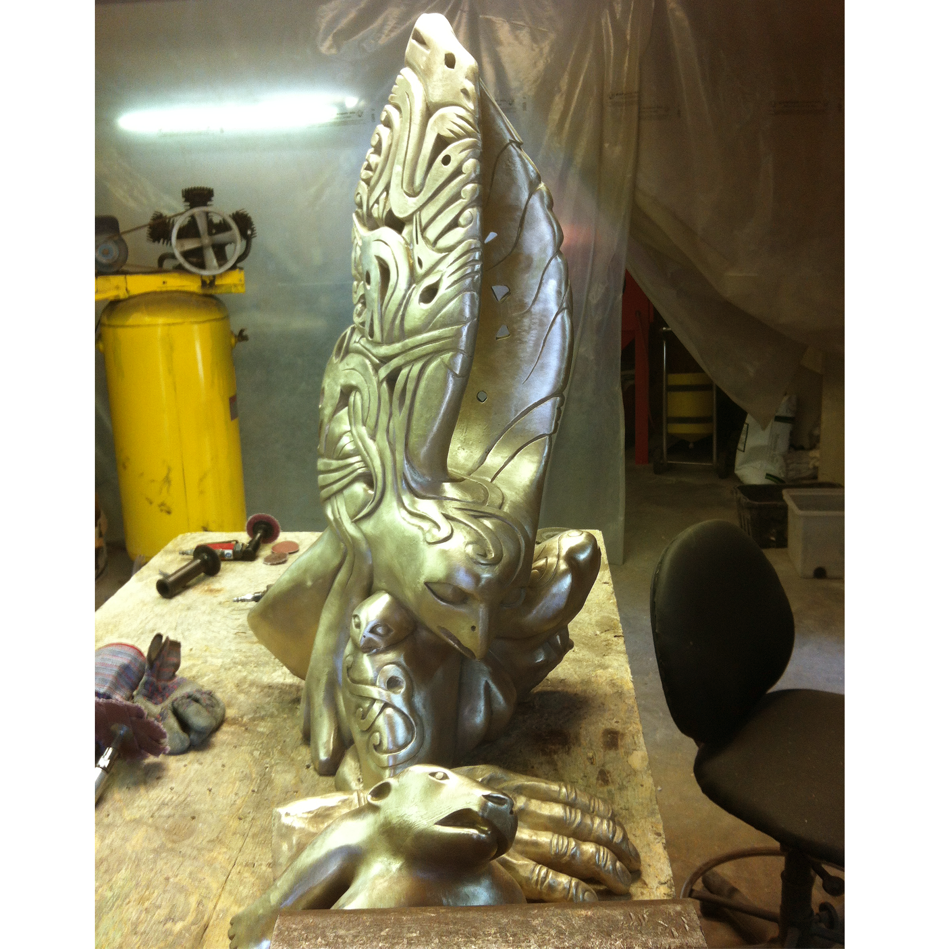 Bronze sculpture recreation of an eagle in a workshop setting