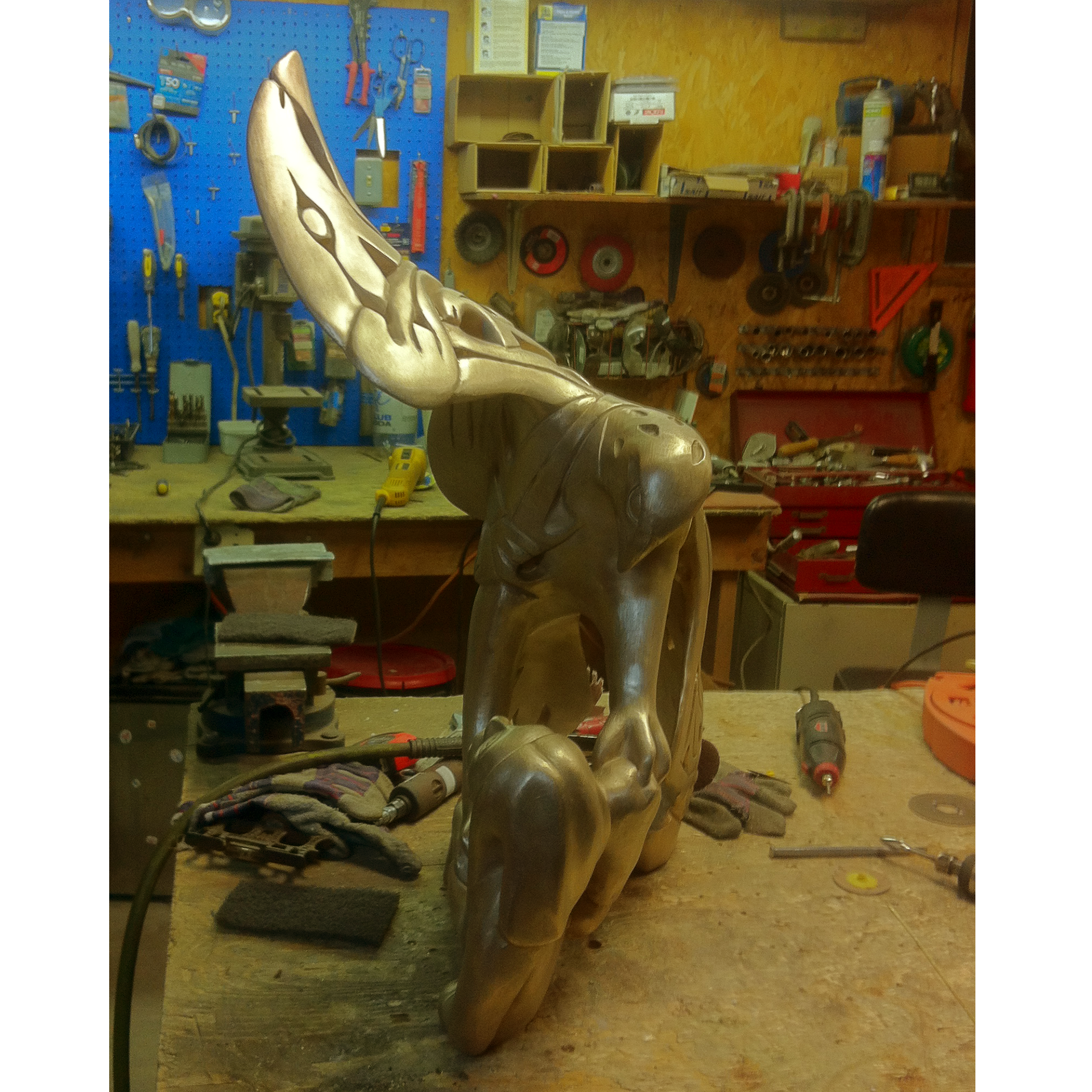 Bronze sculpture recreation of an eagle and a man in a workshop setting