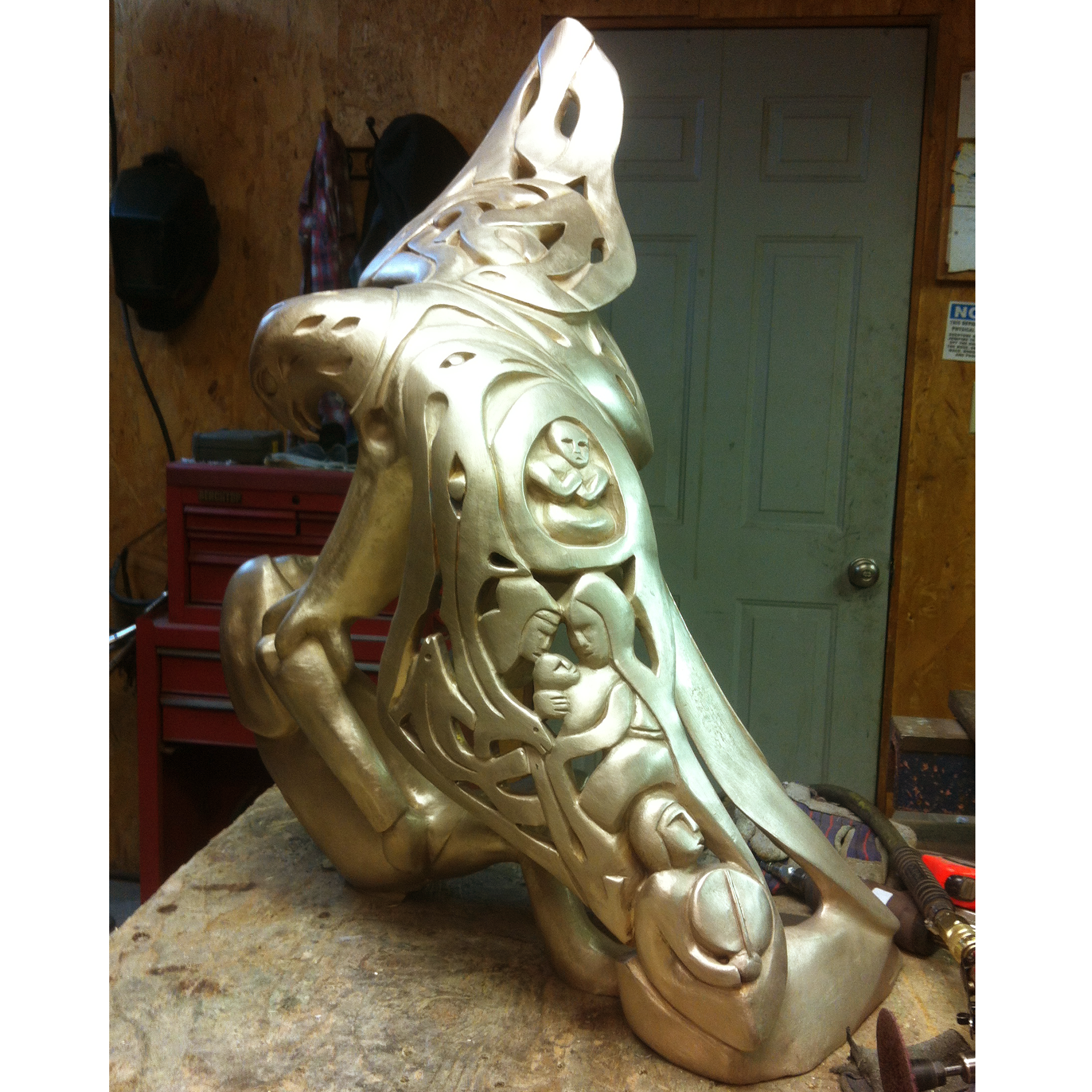 Bronze sculpture recreation of an eagle and a man in a workshop setting