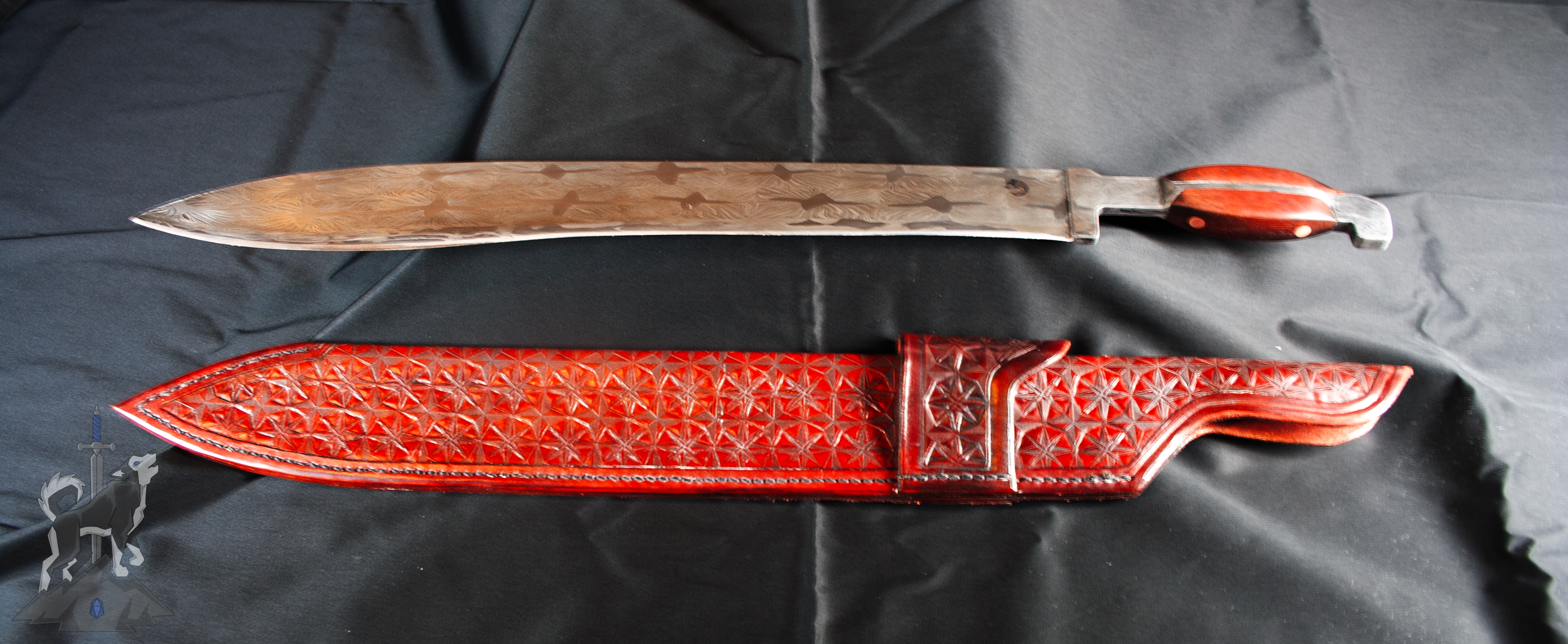 A Damascus kukri hybrid blade and matching leather sheath with hand tooled star patterns and belt loop on a dark background