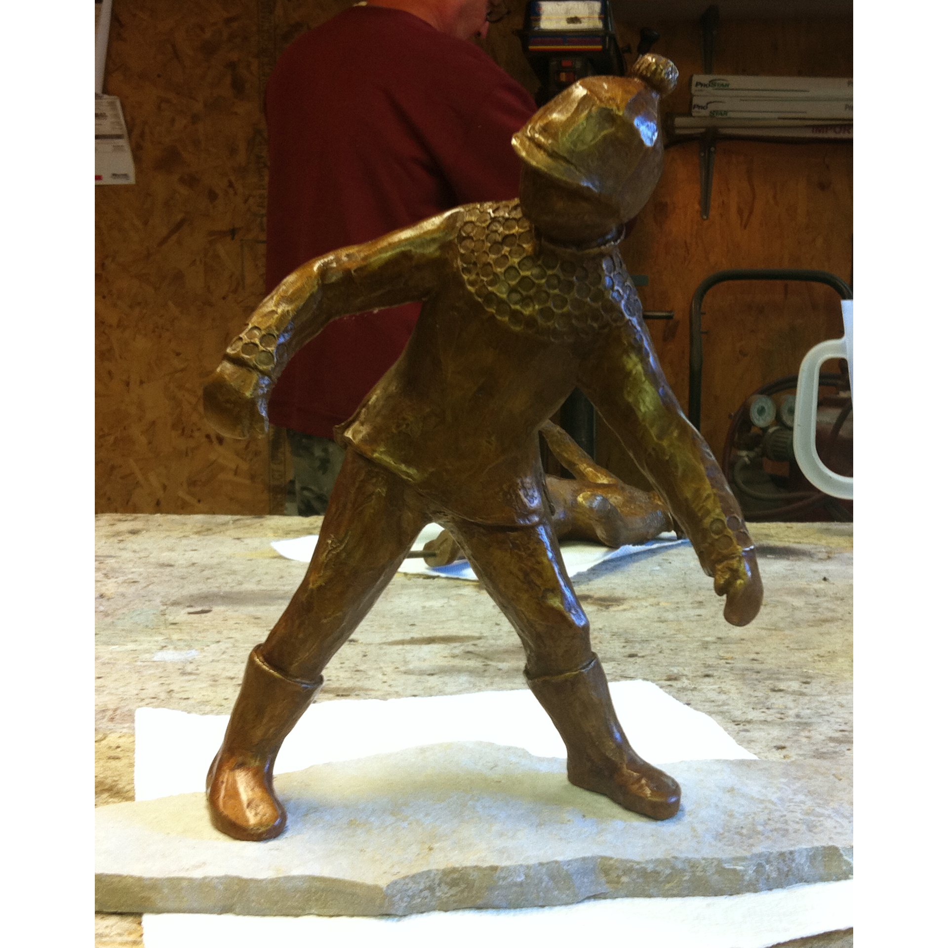 Bronze sculpture recreation of a knight in a workshop setting