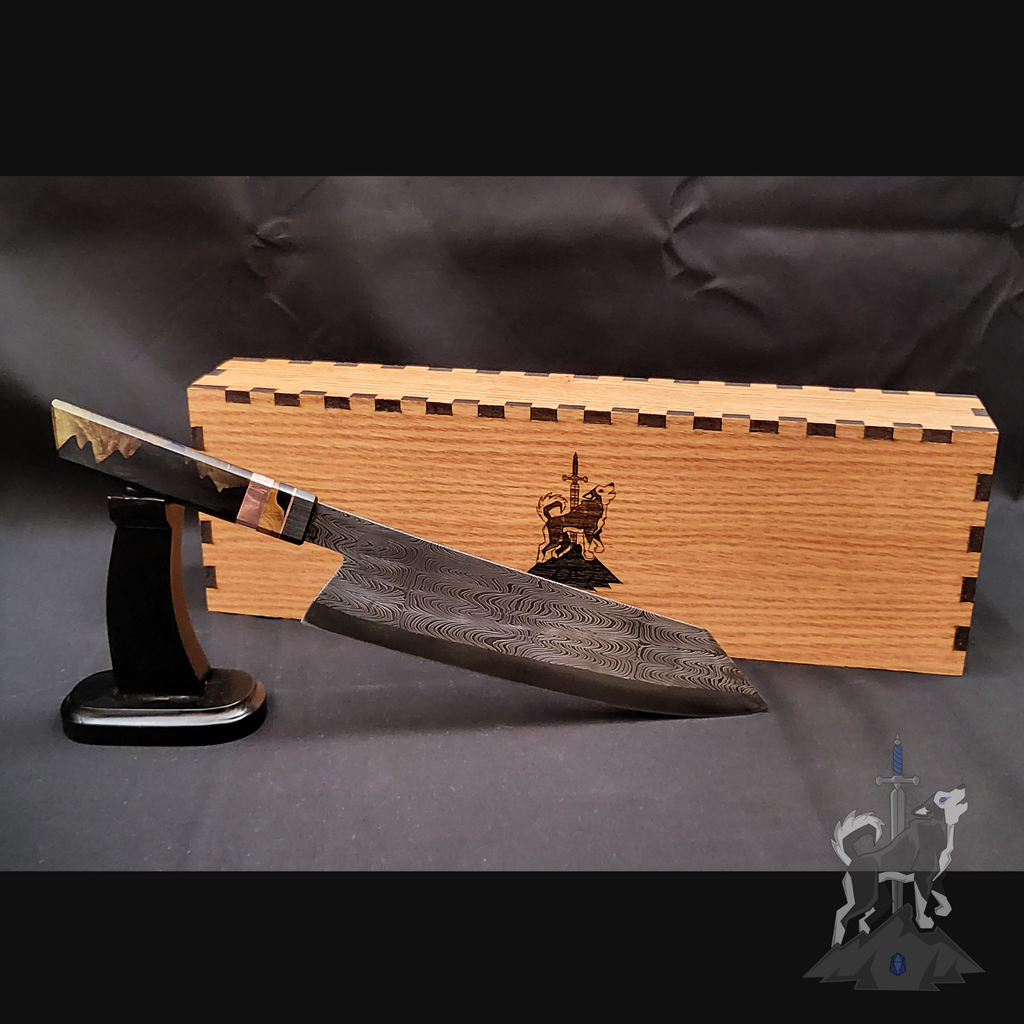 Chef knife with Damascus pattern on a stand next to a wooden box on a dark background
